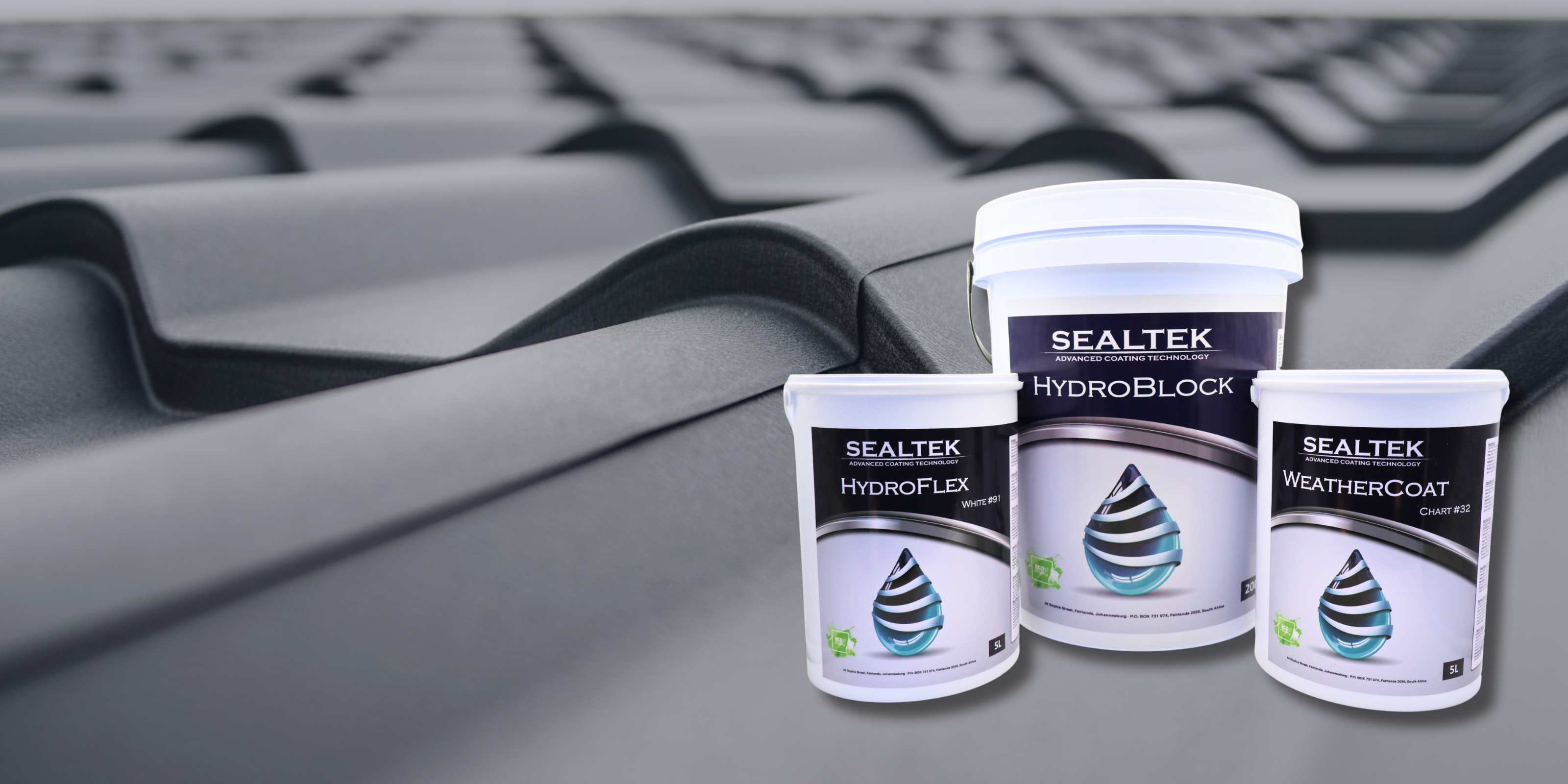 Three containers of Sealtek roofing products on a roof surface.